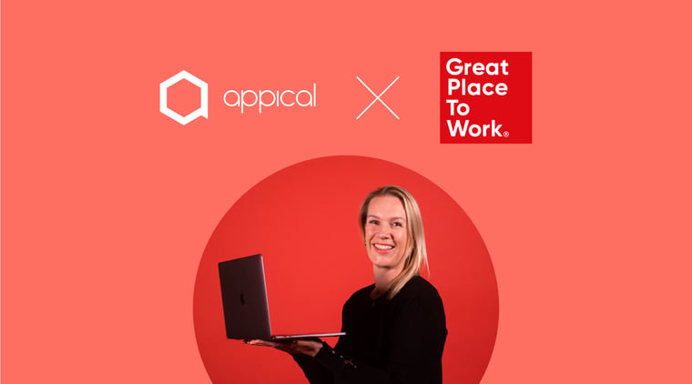 Picture of a happy employee with a laptop in her hands